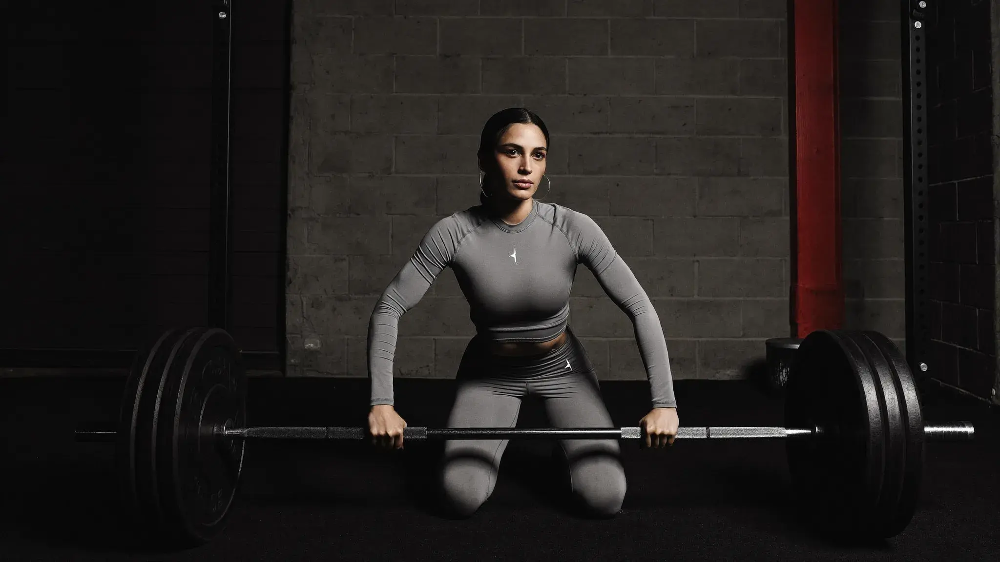 Woman loading a barbell in a gym - beginner strength training program for Christian women