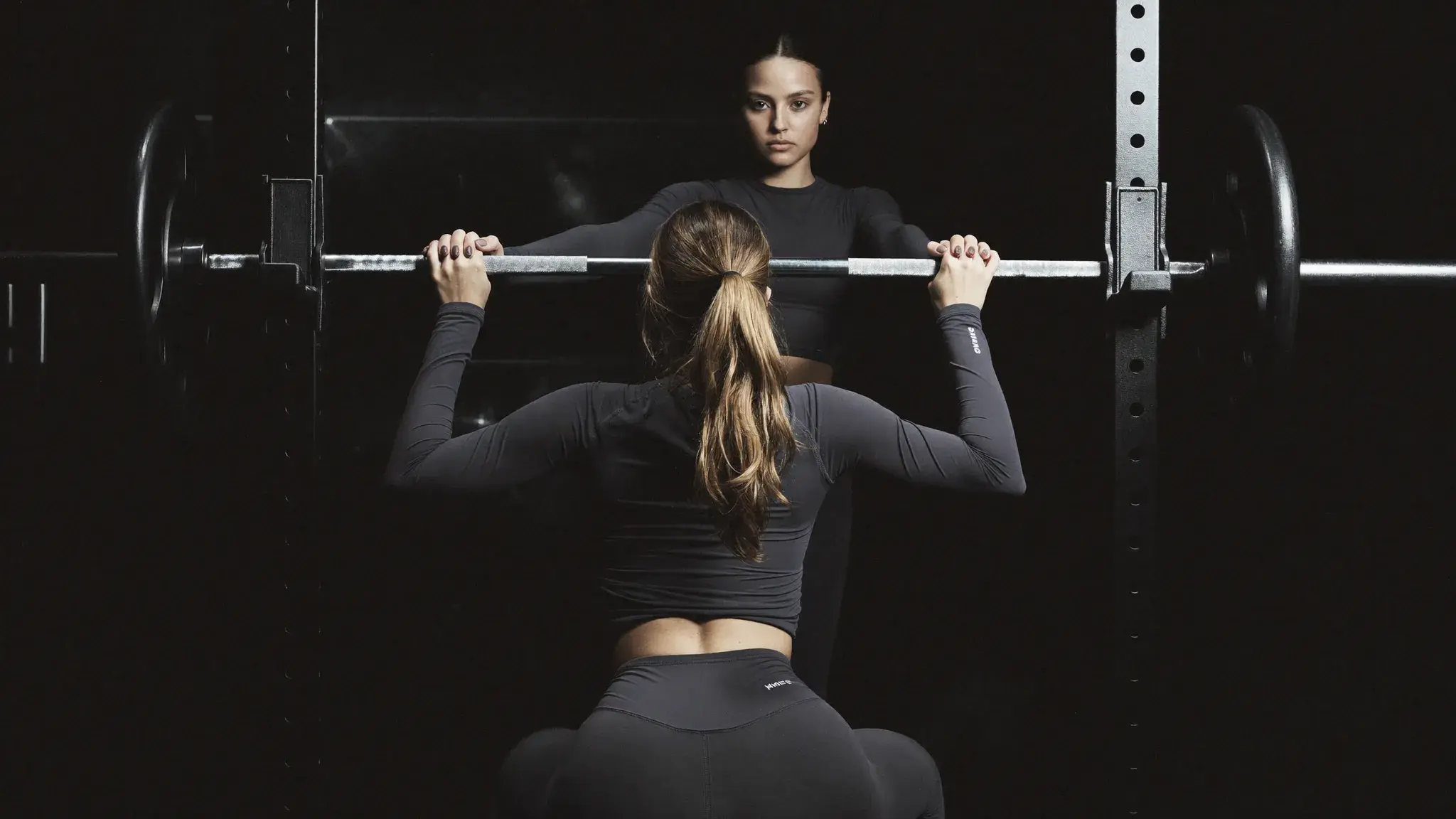 Two women training together in a gym - community and accountability in faith-based women's strength training