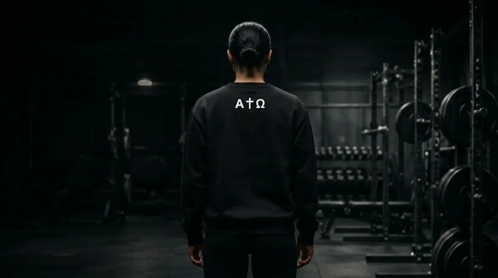 Athlete seen from behind wearing the black Alpha Omega sweater