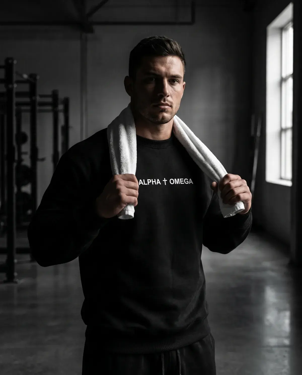 Athlete resting between sets in the black Alpha Omega gear