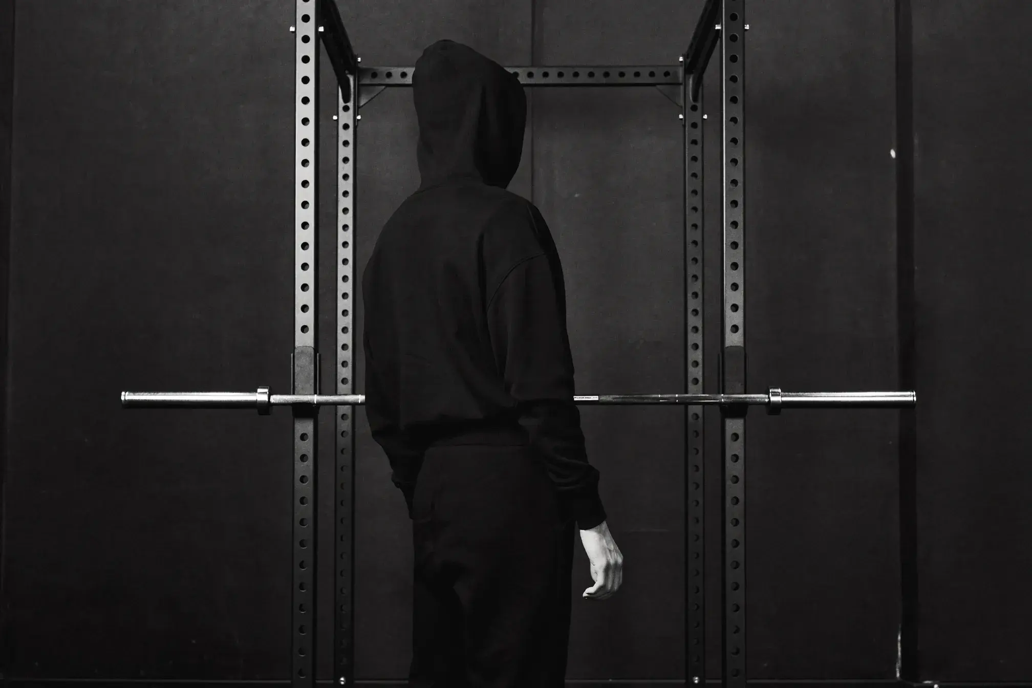 Athlete standing composed in a gym rack wearing faith-identity apparel - Christian gym apparel guide